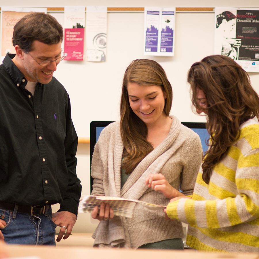 Professors working with a student on an assignment