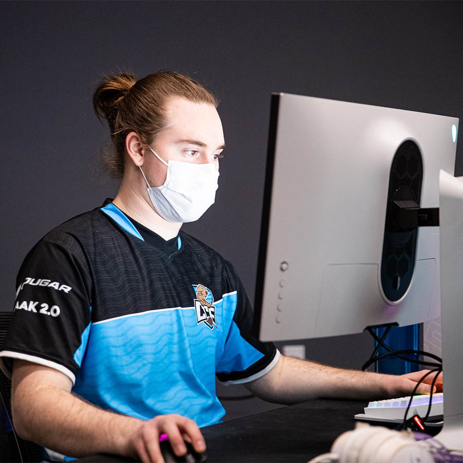 Student competing in esports at a computer
